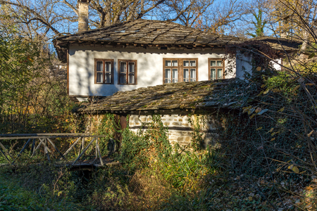Autumn landscape with wooden Bridge and old house in village of Bozhentsi, Gabrovo region, Bulgariaのeditorial素材