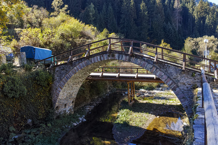 Autumn Landscape with Roman Bridge and Church of the Assumption in town of Shiroka Laka, Smolyan Region, Bulgariaの写真素材