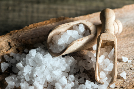 Cyprus sea salt flakes over bark on wooden backgroundの写真素材