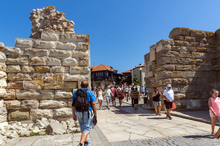 NESSEBAR, BULGARIA - AUGUST 12, 2018: Tourist visiting ruins of Ancient Fortifications at the entrance of old town of Nessebar, Burgas Region, Bulgariaのeditorial素材