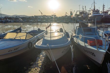 SOZOPOL, BULGARIA - AUGUST 9, 2018: Sunset seascape with Boat at port of Sozopol, Burgas Region,...