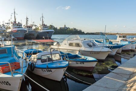 SOZOPOL, BULGARIA - AUGUST 9, 2018: Sunset seascape with Boat at port of Sozopol, Burgas Region, Bulgariaのeditorial素材