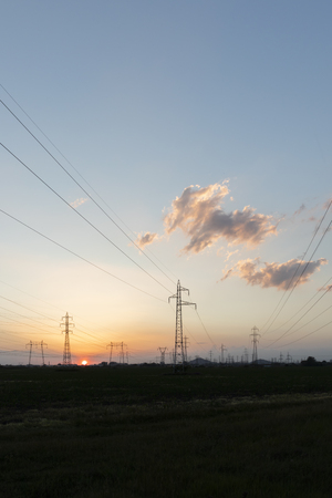 Amazing Sunset view over High-voltage power lines in the land around city of Plovdiv, Bulgariaの写真素材