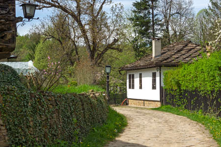 Typical street and old houses at historical village of Bozhentsi, Gabrovo region, Bulgariaの写真素材