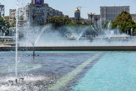 BUCHAREST, ROMANIA - AUGUST 17, 2021: Fountain at Unirii Square at the center of city of Bucharest, Romaniaのeditorial素材