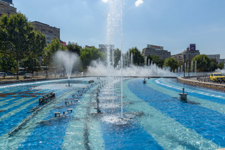 BUCHAREST, ROMANIA - AUGUST 16, 2021: Fountain at Unirii Square at the center of city of Bucharest, Romaniaのeditorial素材
