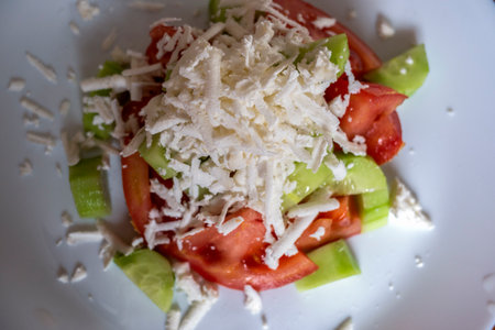 Traditional Bulgarian Shopska salad with tomatoes, cucumber and feta cheese and olive oilの写真素材