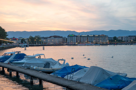 GENEVA, SWITZERLAND - JUNE 17, 2023: Amazing Sunset view of Rhone River and city of Geneva, Switzerlandのeditorial素材