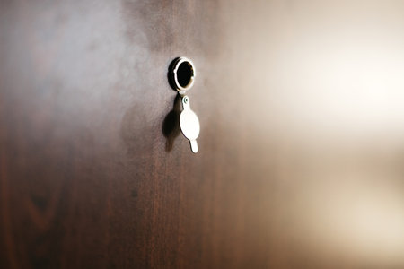 Through a peephole in the brown door of an apartment or houseの写真素材