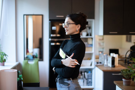 woman in glasses looking out the windowの写真素材