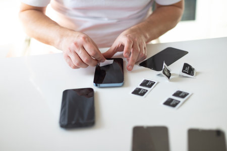 The process of replacing a protective glass on a smartphone. High quality photoの写真素材
