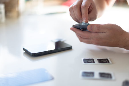 The process of replacing a protective glass on a smartphone. High quality photoの写真素材