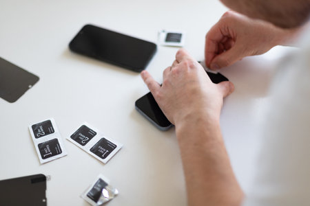 The process of replacing a protective glass on a smartphone. High quality photoの写真素材