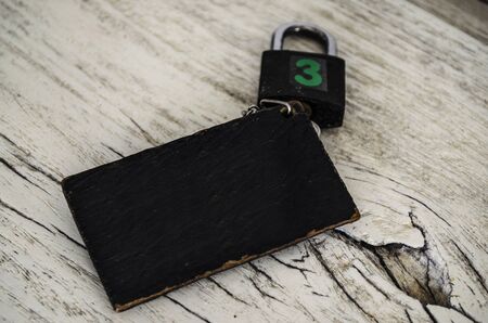 key with copy space and blank label for your text message on plate woodの写真素材