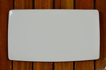 White Plate on wooden tray close-upの写真素材