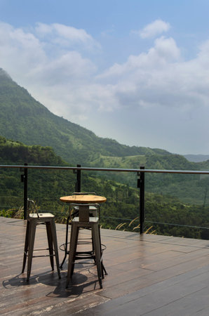 Magnificent outdoor terrace with chairs on sunny terrace with bay view and decoration in contemporary home. Mountain View.の写真素材