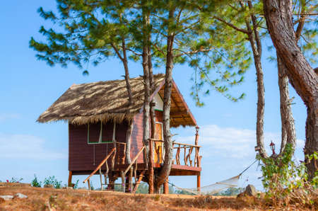 Wooden cottage house in a pleasant country farm to live in on a clear day with beautiful blue sky.の写真素材