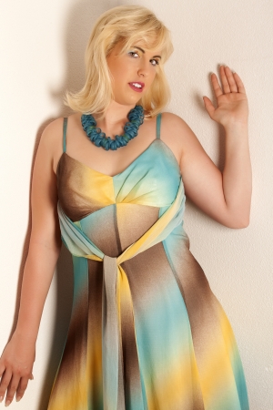 Young blonde woman in a large size in a colorful summer dressの写真素材