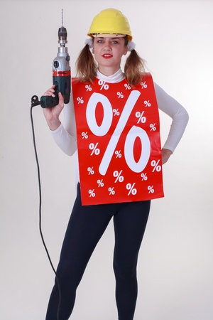 Young woman with drill and helmet Attract percent Actionの写真素材