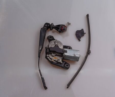 Front side of a broken tail wiper after a visit by car in the car wash with wiper arm and wiper...