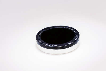 Flat metal box with black lid and silver bottom isolated on white.の写真素材