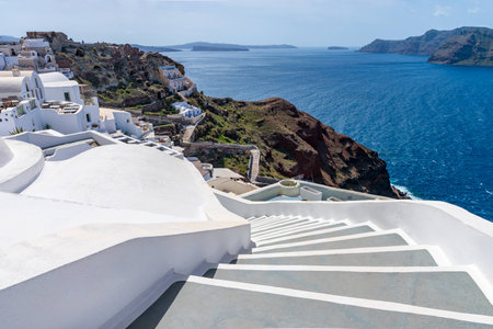 White and grey color elegant staircase perspective in Oia, Santorini, Greece with sea ocean as...