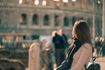 Young asian woman roaming in the street nearby Colosseum at Rome, Italy while on vacation.の写真素材