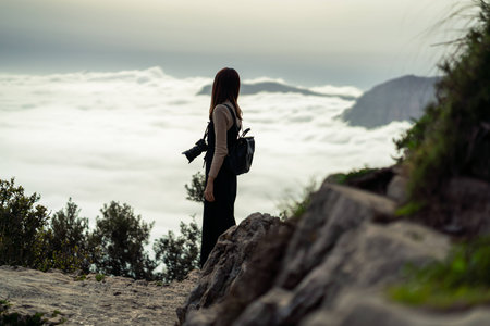Young asian girl enjoy the view of beautiful scenery while hiking along the mountain trail located at Positano, Italy.の写真素材