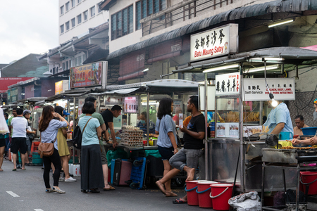 People wandering around the street in George Town, Penang, Malaysia in search for the best street food for their dinner.のeditorial素材