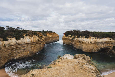 Loch Ard Gorge scenery viewed from the cliff top at Port Campbell National Park, Victoria, Australia during cloudy morning.の素材 [FY310152947219]