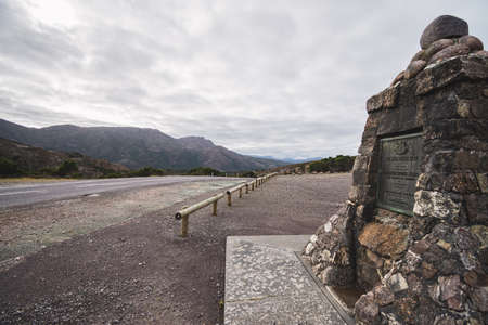 The west coast road against mountain range and bright sky with memorial at Tasmaniaの写真素材
