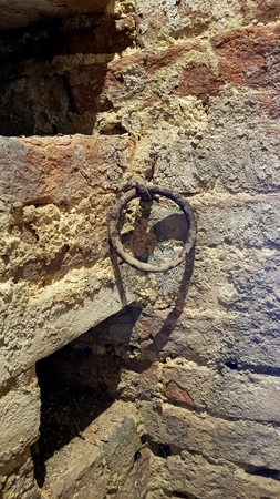 Ancient rusty wall ring inside a medieval castle in the center of italyの写真素材