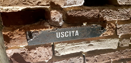 A rusty exit sign in a stone wallの写真素材