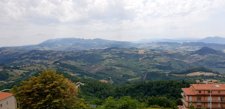 Cloudy and sunny sky with amazing italian summer landscapeの写真素材