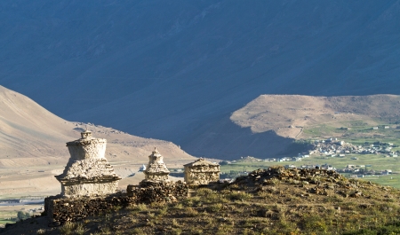 Buddhist stupas in the Zanskar  valley on the background of the mountains and villageの写真素材