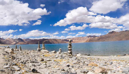Pangong Tso mountain lake panorama with Buddhist stupas in forefront (Ladakh, India)の写真素材