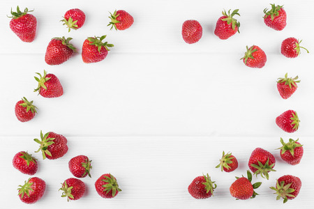 Strawberries with green leaf on white wooden backgroundの写真素材