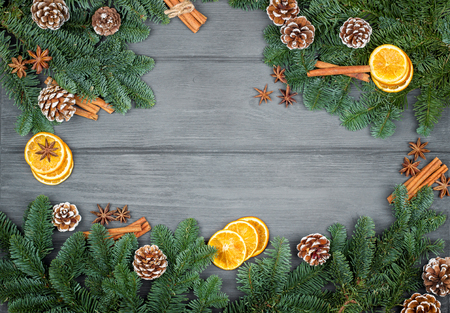 Christmas decorations on a wooden background with cinnamon and dried orange slices. の写真素材