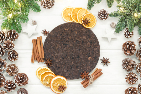 Christmas composition on a white background of Christmas decorations. Tree branches, cones, cinnamon sticks, star anise, dried oranges. Top view, flat layの写真素材