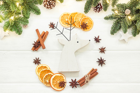 Christmas composition on a white background of Christmas decorations. Tree branches, cones, cinnamon sticks, star anise, dried oranges. Top view, flat layの写真素材