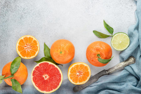 Set of citrus on table: mandarin, grapefruit, lime, tangerine with a knife. Fresh organic juicy fruits. の写真素材