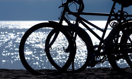 Silhouette of two bikes at the beachの写真素材