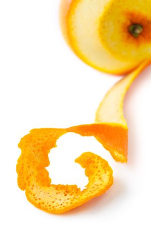 Orange with peeled skin on a white,shallow focusの写真素材