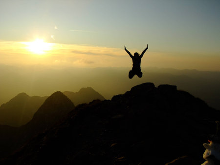 Woman jumping Hands up on the Top of the Nebelhorn Mountains in Germany Alpsの写真素材