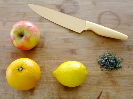 Flat Lay Composition of Orange, Apple, Lemon, Herbs and a Knife on wooden Backgroundの写真素材