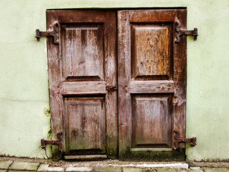 Locked Shutter of the Window of the old ancient Building in the Oldtownの写真素材