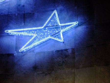 Christmas Decoration blue Star is hanged on Concrete Wallの写真素材