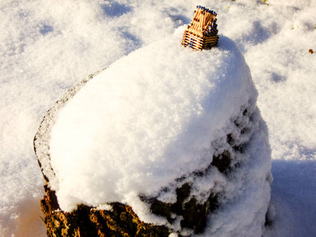 Little House made of blue Matches is standing outdoor on Snowy Cliff during Sunsetの写真素材
