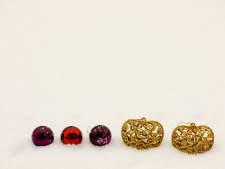 Christmas Composition with Baubles and golden Hearts on Snow outdoorの写真素材