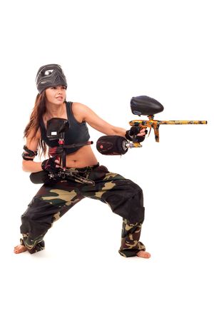 Sexy young girl posing like playing paintballの写真素材